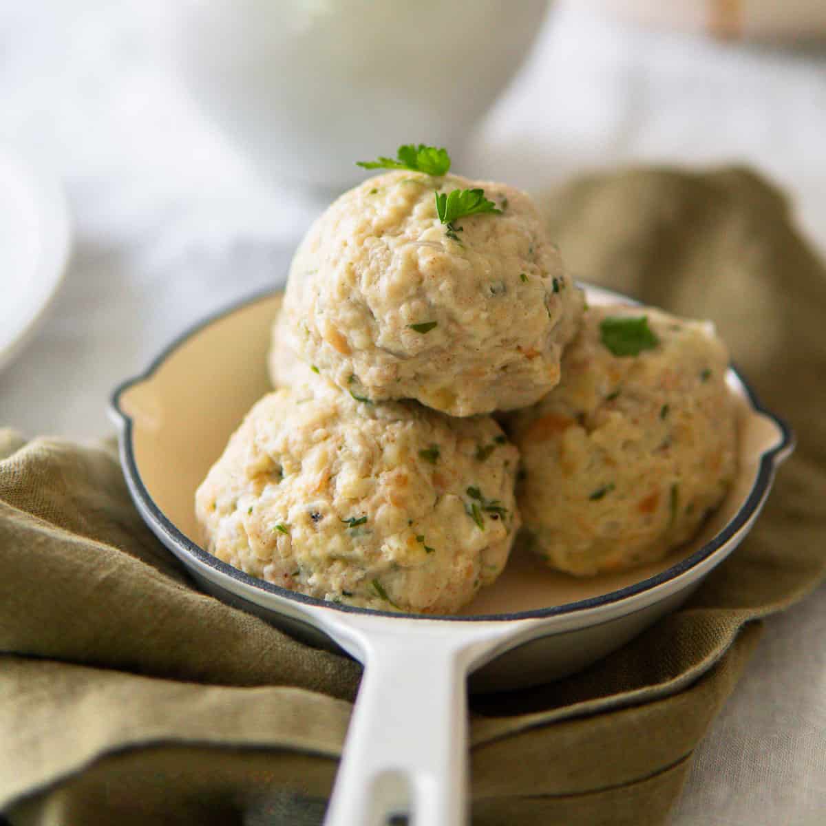 German bread dumplings stacked in a small serving skillet.