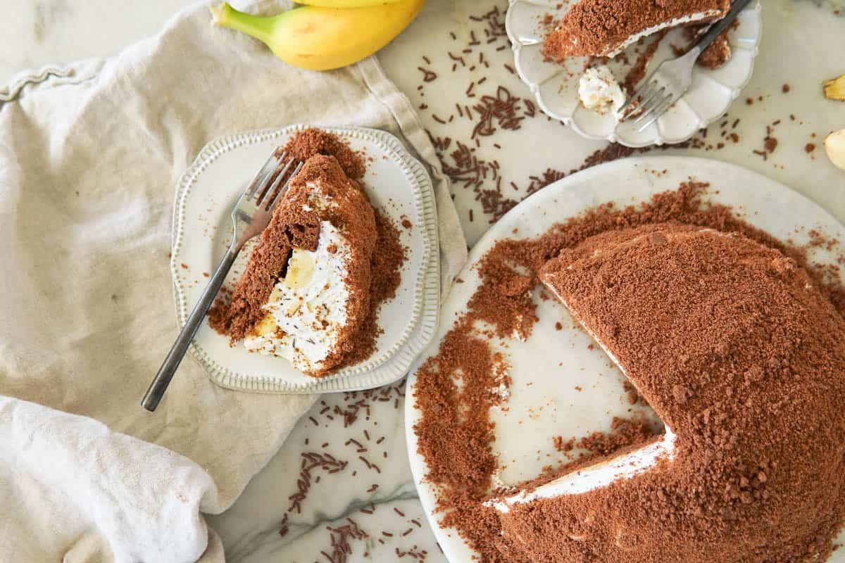 cake on a platter and 2 plates with cake slices