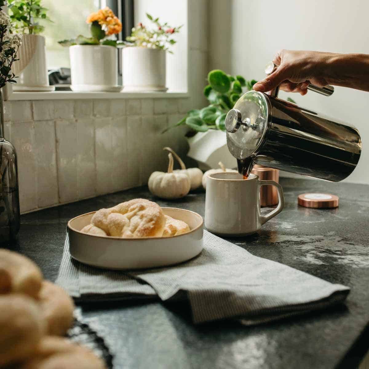 pouring coffee next to a plate of German sweet pretzels