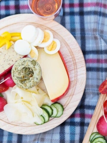 meats and cheese boards on picnic blanket
