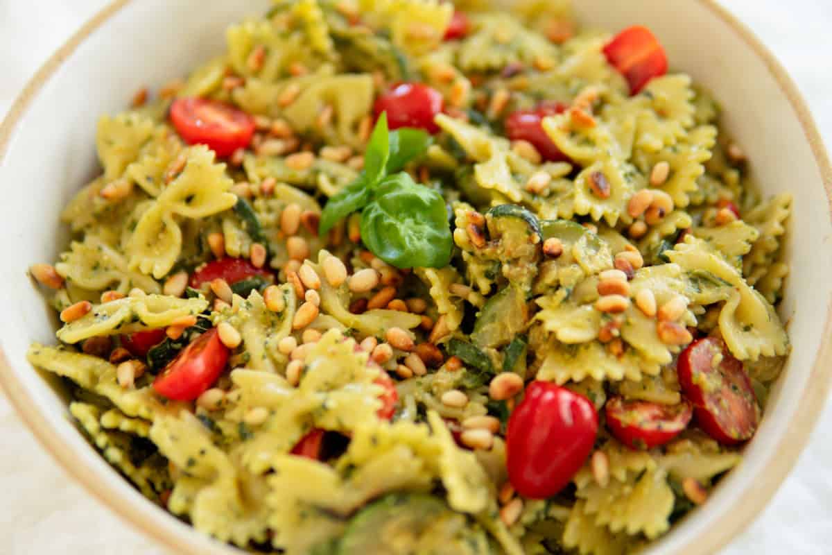 Closeup of pesto pasta salad in a serving bowl.