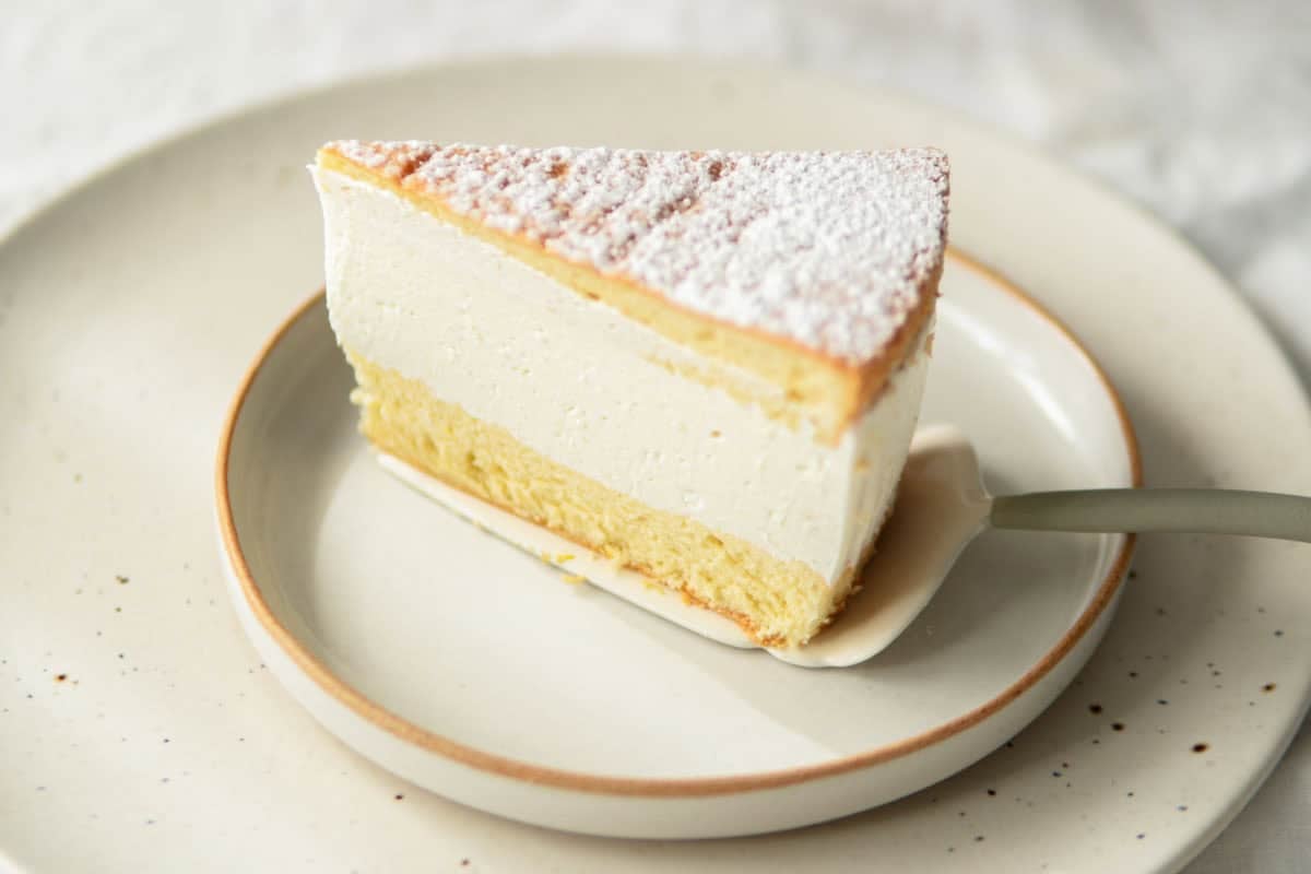 A close-up of a slice of Käse-Sahne-Torte on a plate.