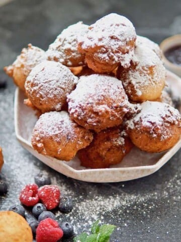 German mini donuts dusted with powdered sugar.
