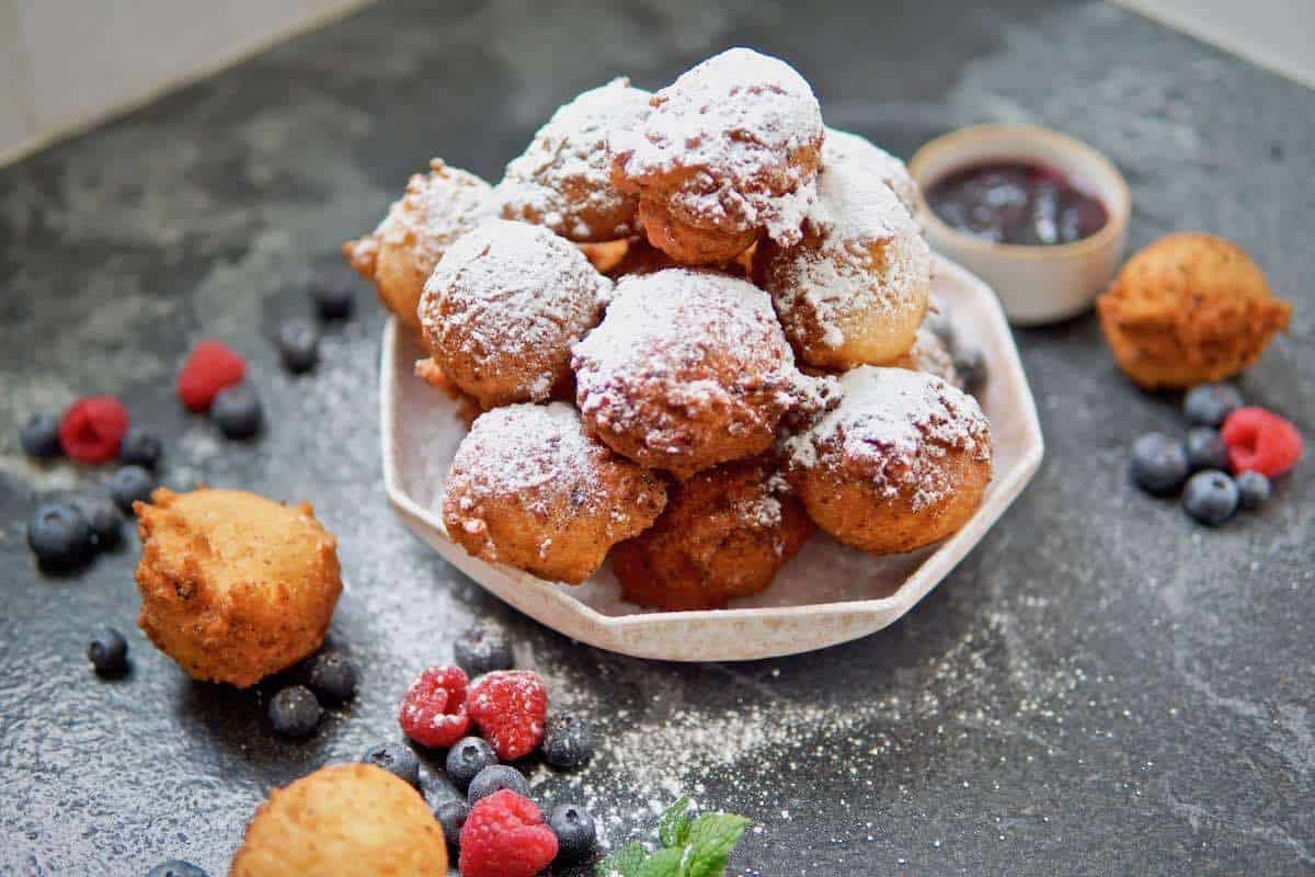 German mini donuts dusted with powdered sugar.