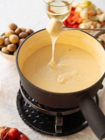dipping bread in a pot of cheese fondue