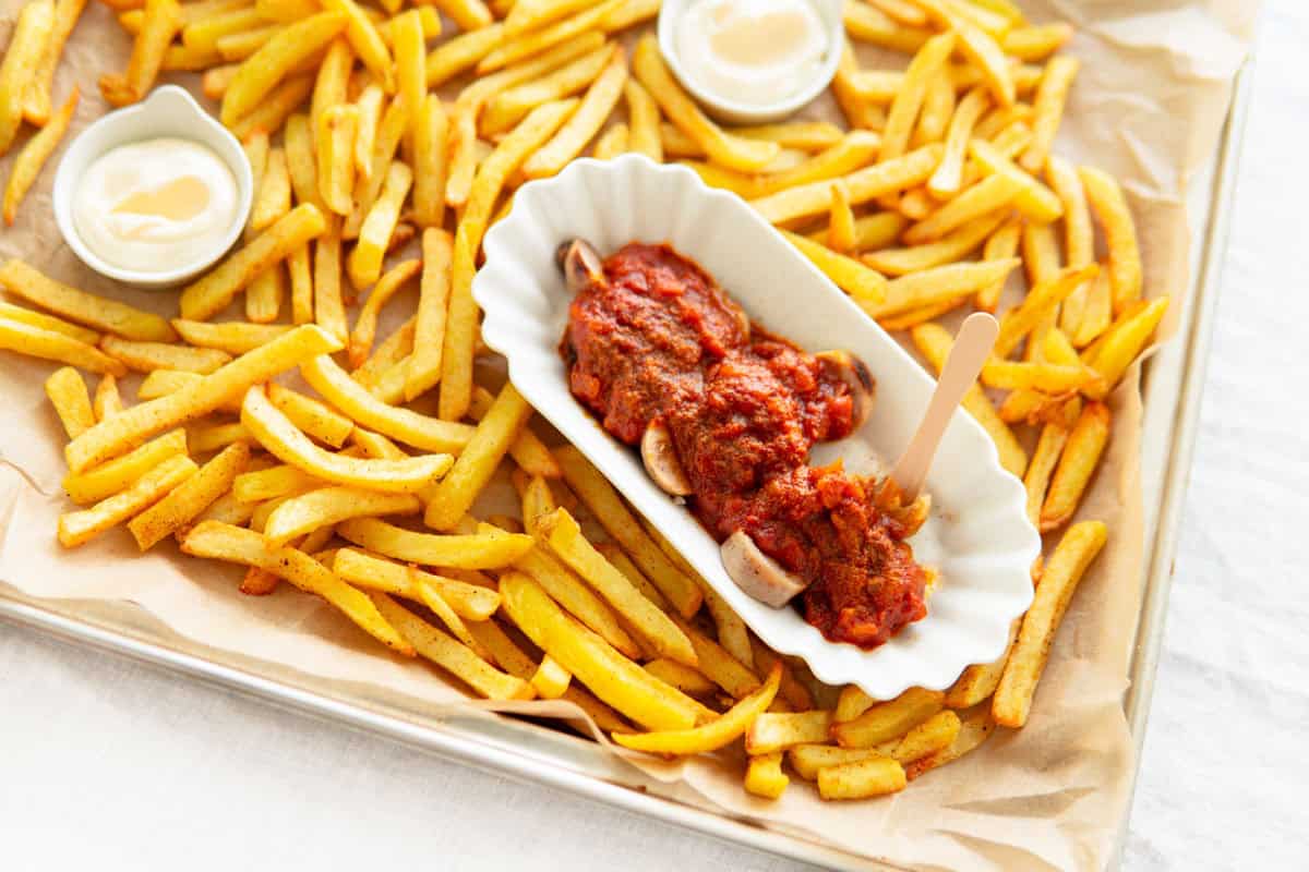 Currywurst on a platter with French fries.