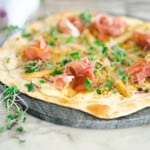 White asparagus flatbread with prosciutto and cheese