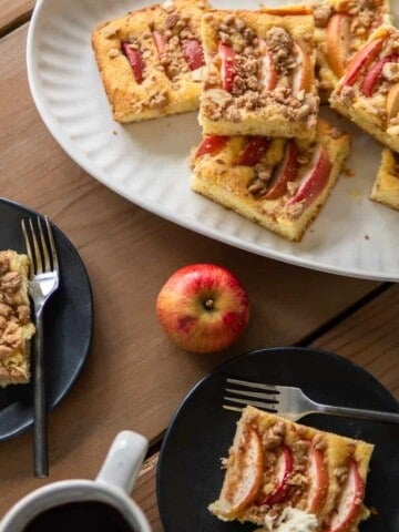 slices of apple cake on platter and plates