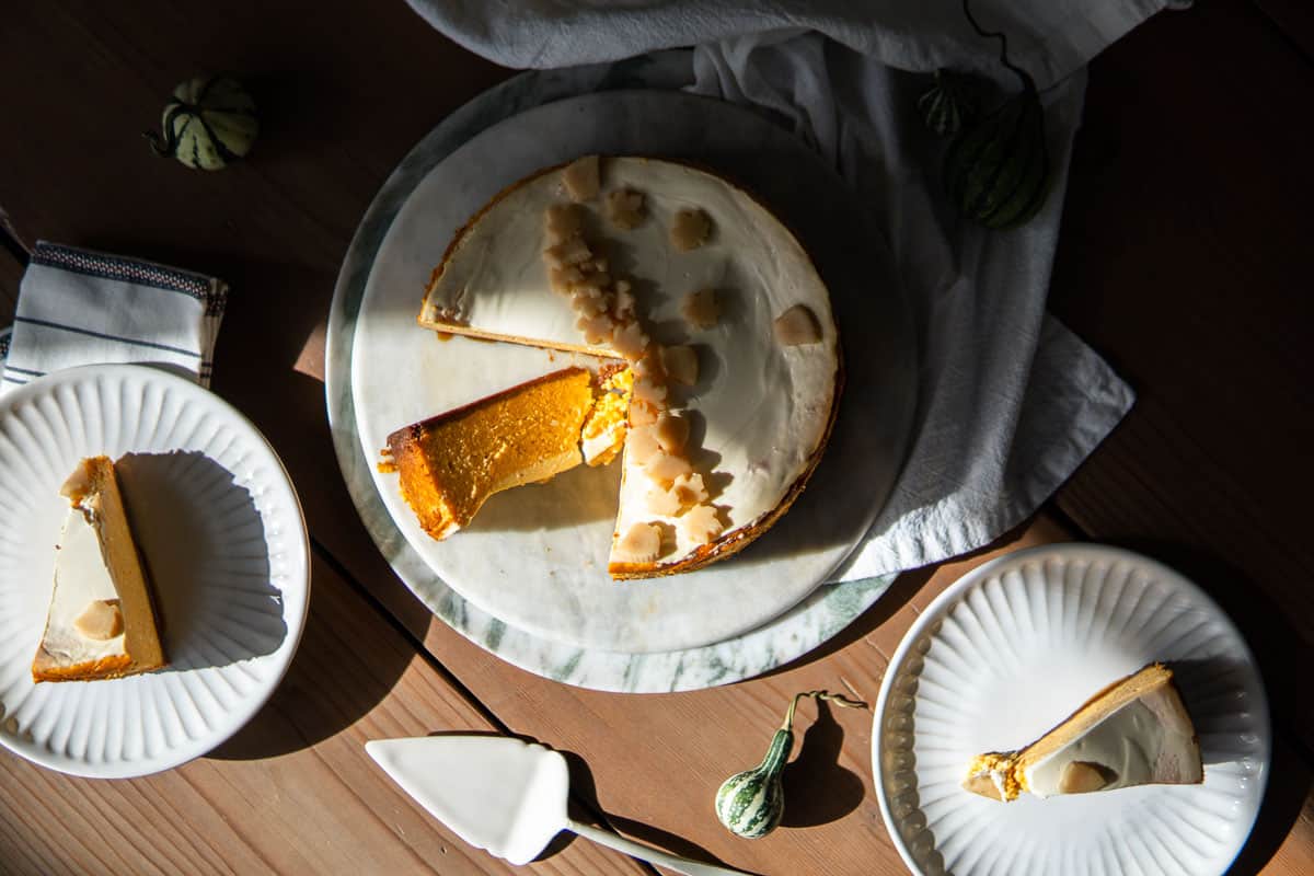 top view of pumpkin cheesecake with individual slices sitting on the side.