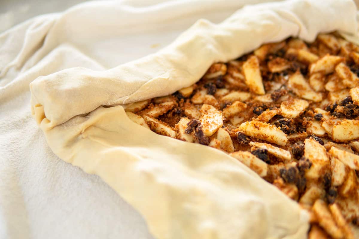 rolling the dough with the filling using a clean linen towel