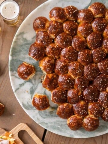 pretzel beer bubble bread sitting on a marble platter