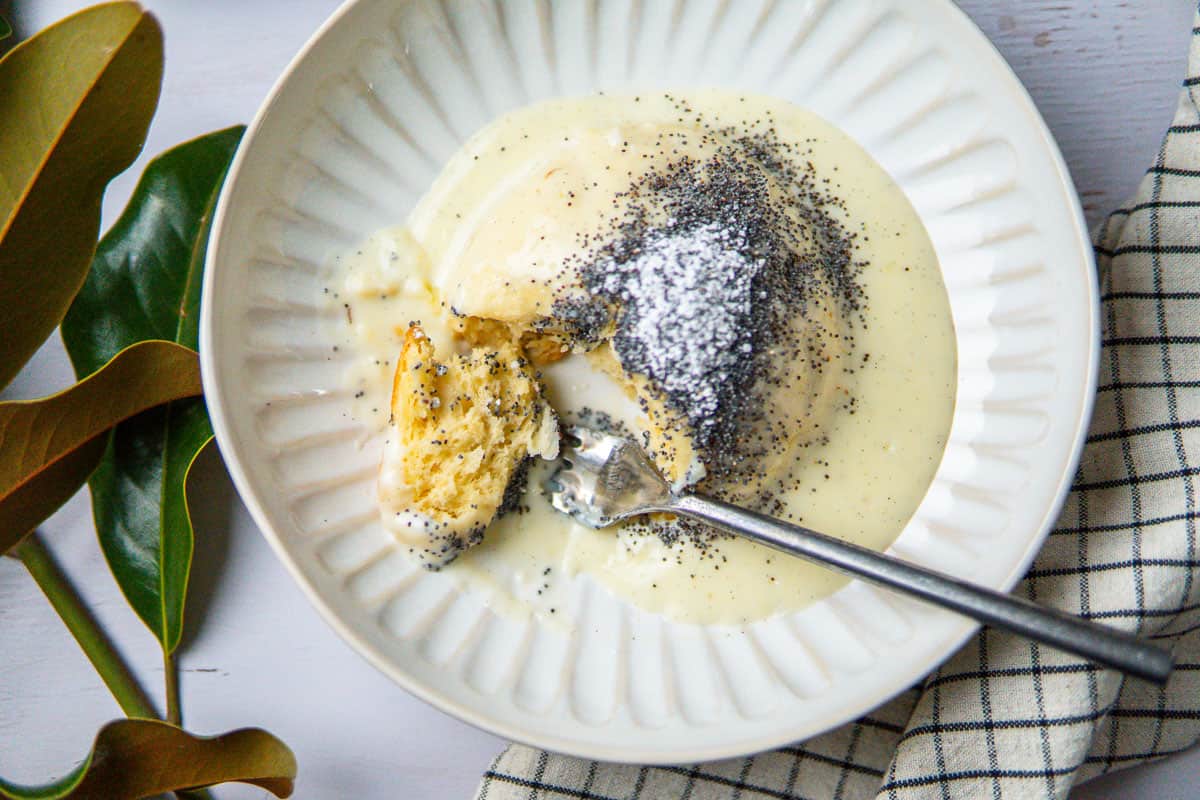 plate with dampfnudel, vanilla sauce and poppy seed topping