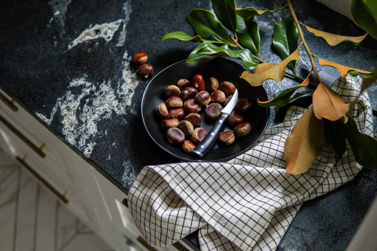 chestnuts on a plate with a paring knife