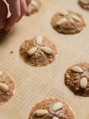 placing almonds on Lebkuchen before baking
