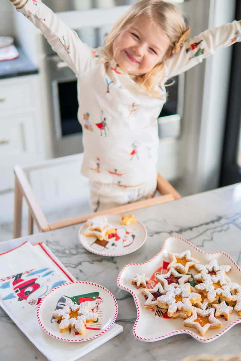 a smiling child and finished Linzer cookies