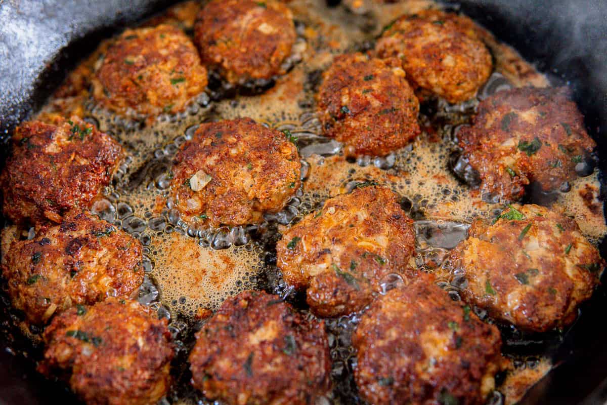 cooking German hamburgers in a skillet