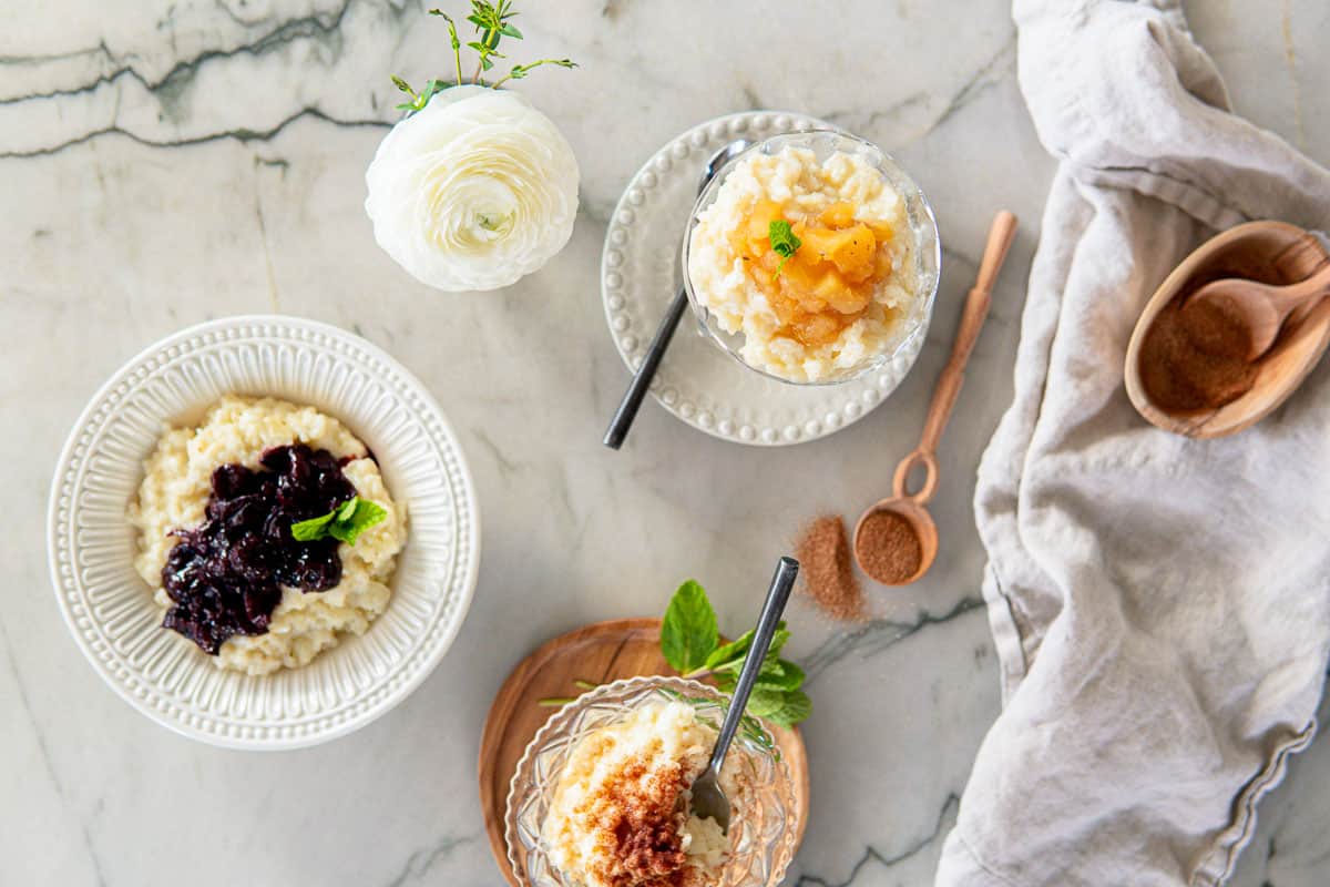 homemade rice pudding topped with cinnamon sugar, cinnamon apples and hot cherries