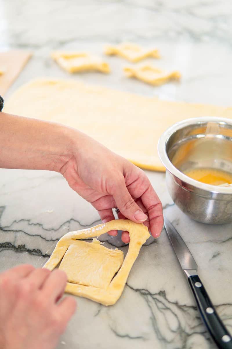 cutting out pastries from German croissant dough