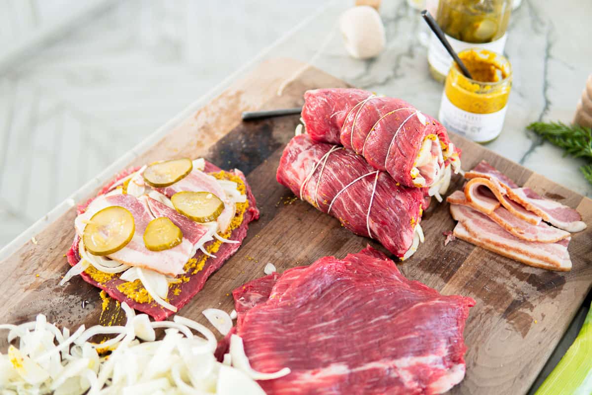 filling flank steak with bacon, mustard, onion and pickles