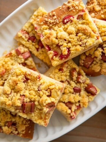 rhubarb cake slices on a white platter