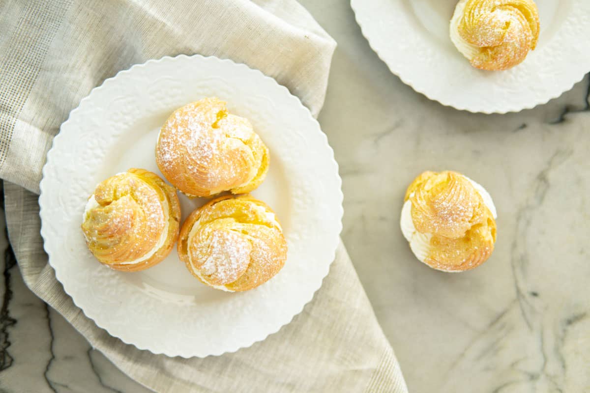 top view of cream puffs on white plates