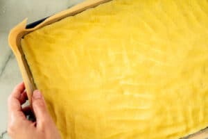 pressing down the bottom layer of Nussecken by hand