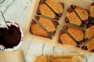 dipping German nut bars in chocolate