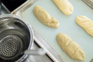 dipping pretzel hot dog buns in lye solution