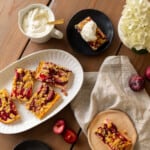 German plum cake on a platter with whipped cream