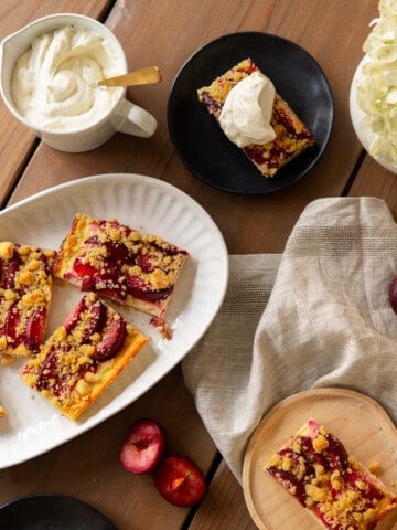 German plum cake on a platter with whipped cream