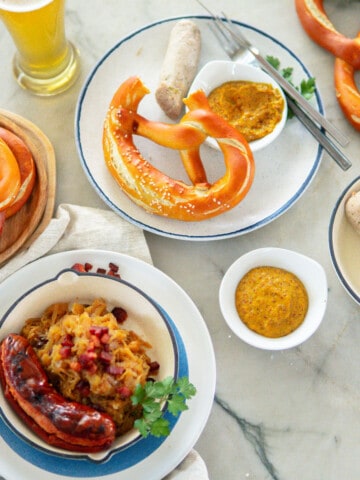 Oktoberfest food such as pretzels, beer, weisswurst, bratwurst and sauerkraut