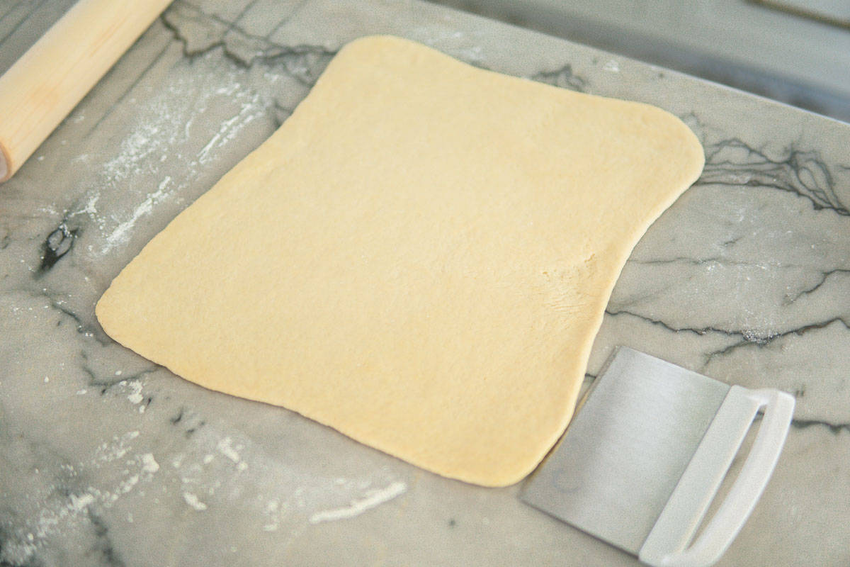 rolling out dough for apple cinnamon rolls