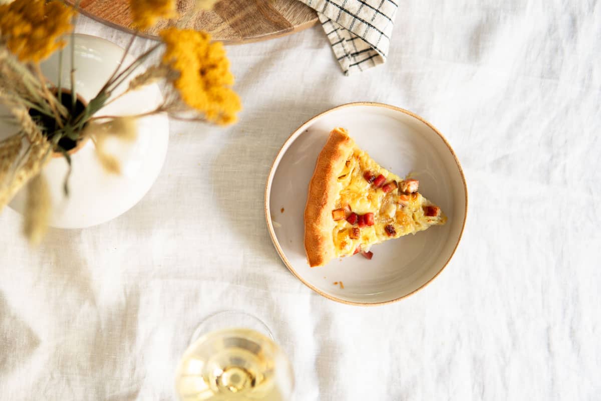 slice of German onion pie with a glass of Riesling