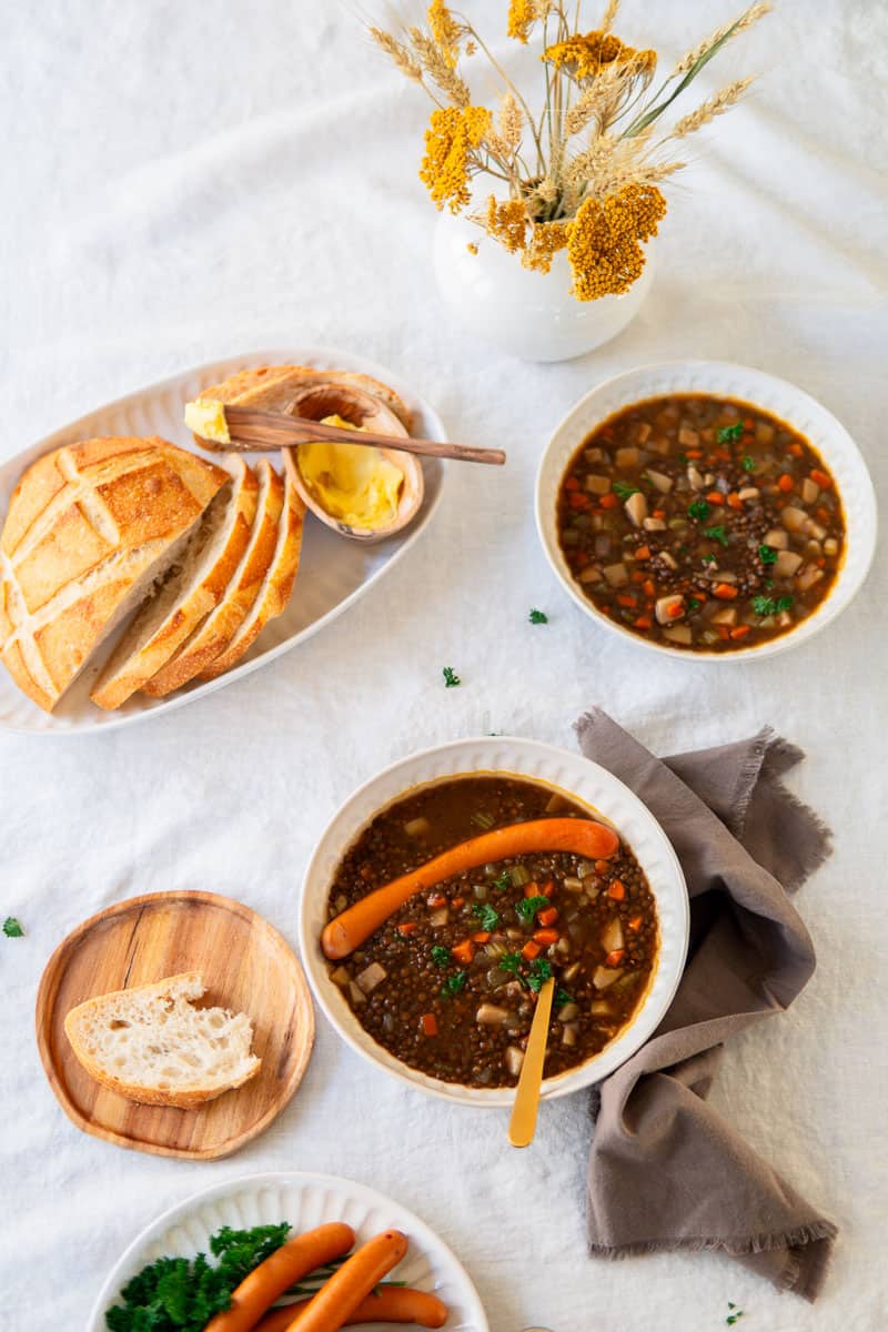 two bowls of lentil soup with bread