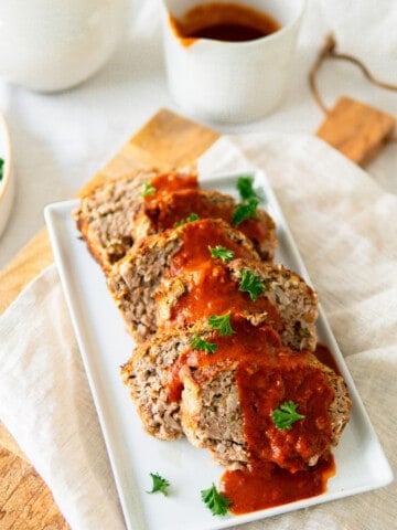 German meatloaf on a platter with sauce