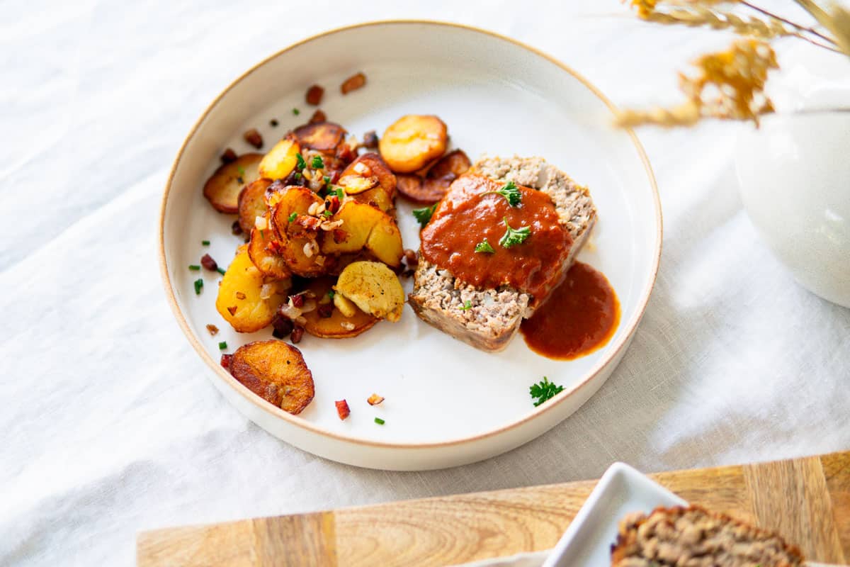 German meatloaf on a plate with potatoes