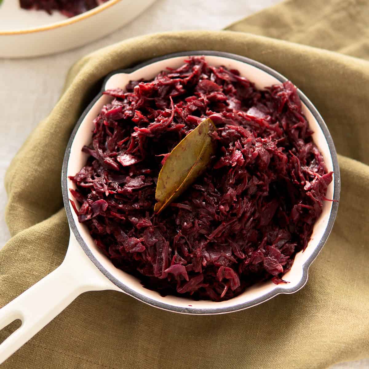 Authentic German red cabbage in a small white skillet.