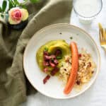 German mashed peas on a plate with sauerkraut, bacon and Wiener sausages.