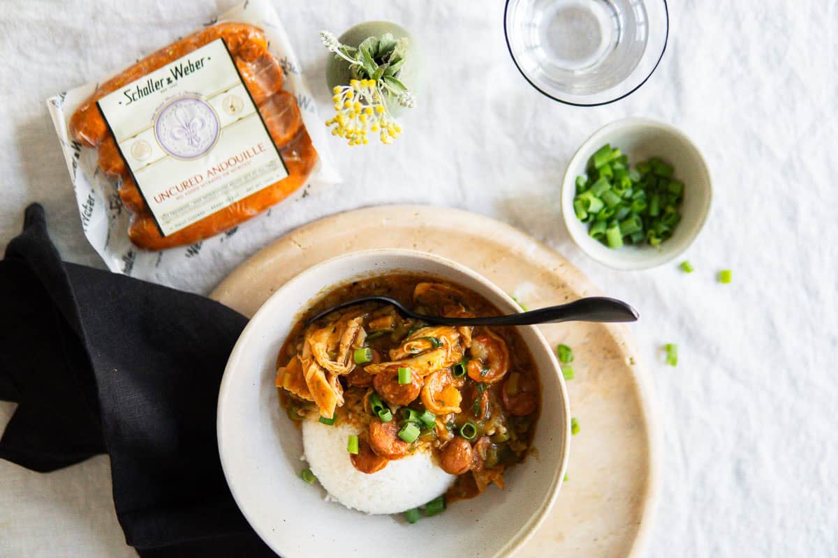 Schaller & Weber Andouille sausage used for this authentic Gumbo recipe next to a bowl a Gumbo.