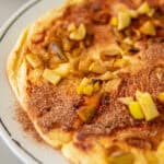 Large German apple pancake topped with cinnamon sugar.