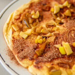 Large German apple pancake topped with cinnamon sugar.