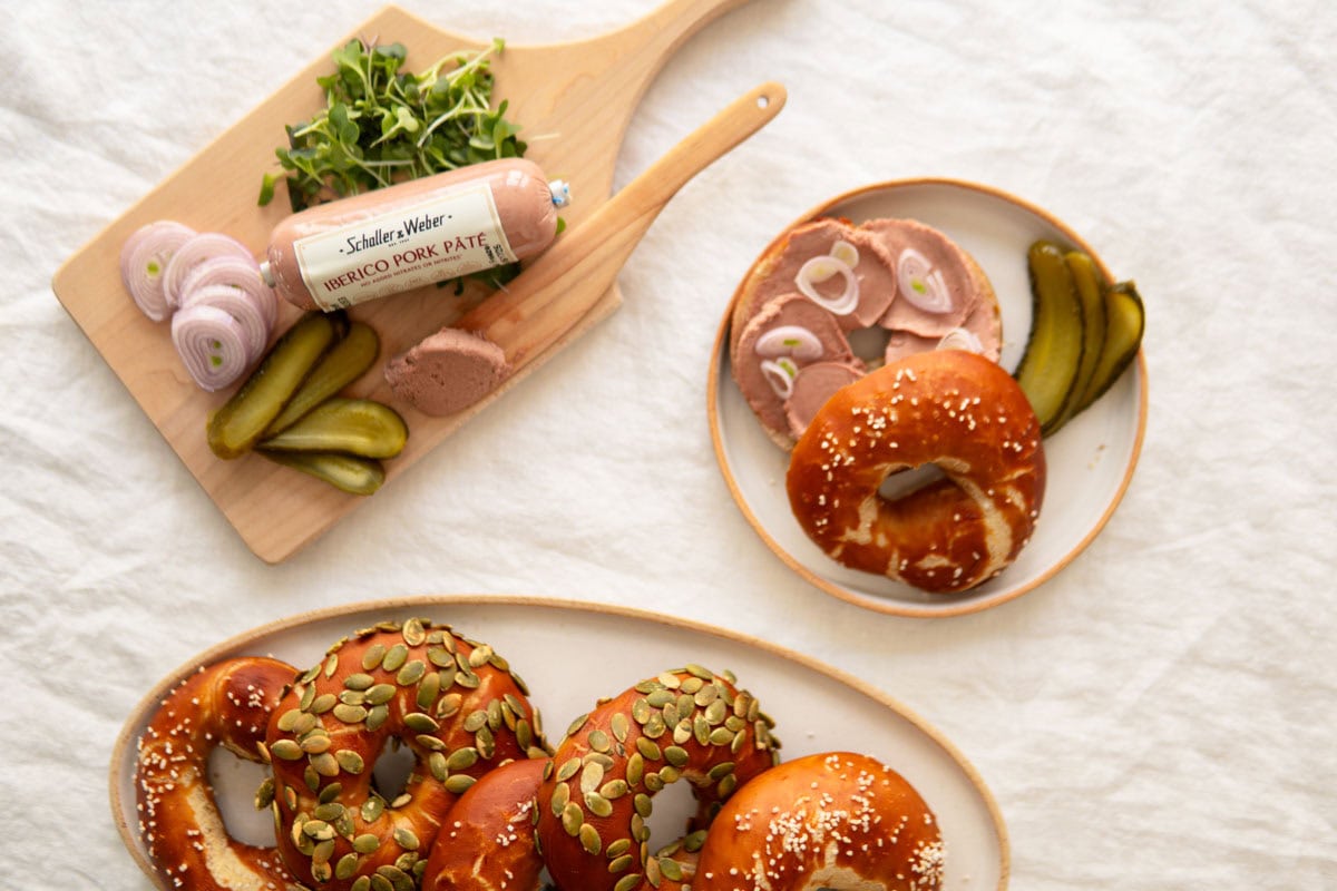 Pretzel bagels with iberico pork paté next to it.