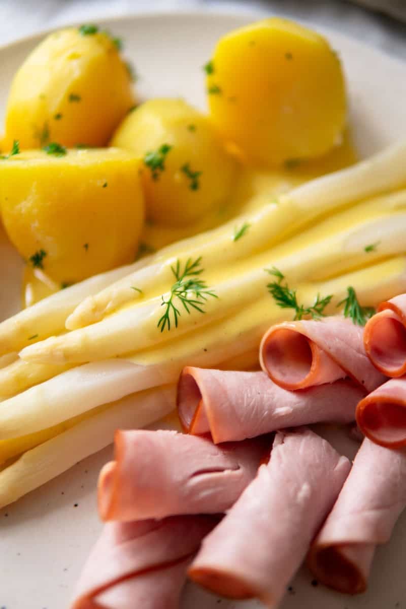Closup of a traditional German white asparagus meal.