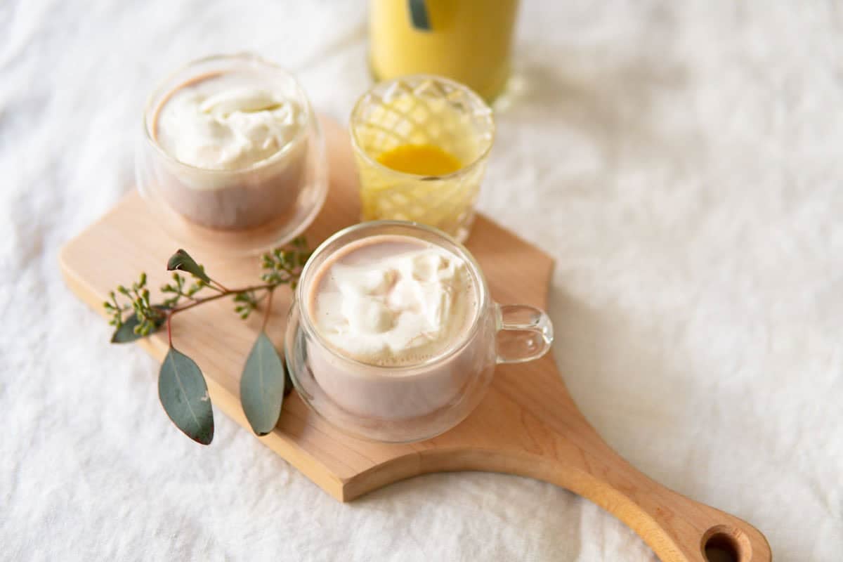 A cup of hot chocolate with spiked egg nog and whipped cream.