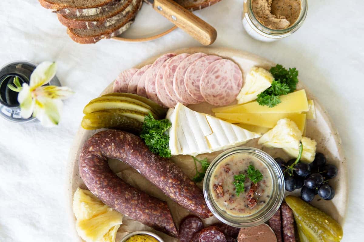 German Vesperplatte meat and cheese board with slices of fresh bread.