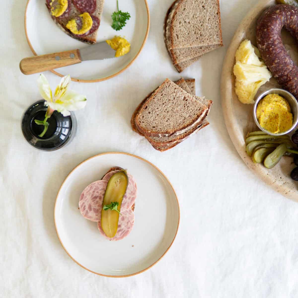 open faced sandwiches next to a German meat and cheese board.