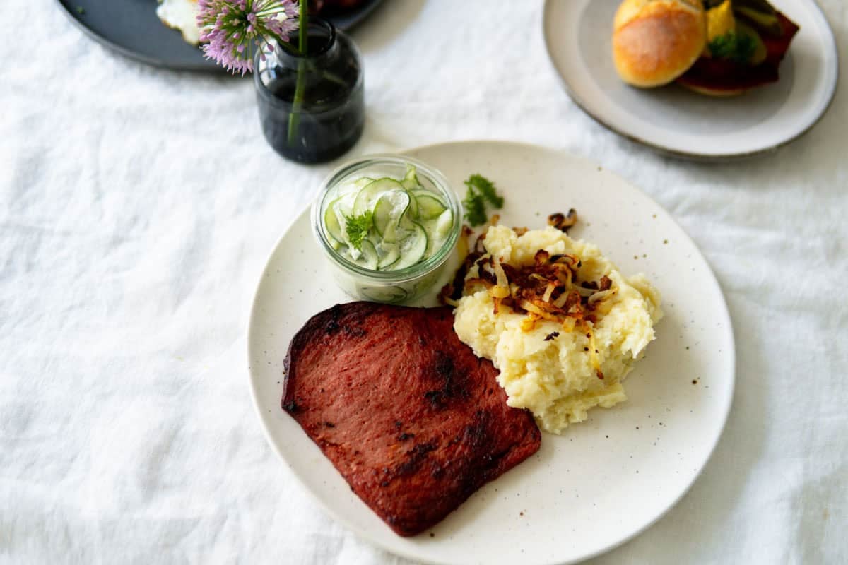 Leberkäse with mashed potatoes. fried onions and a cucumber salad.