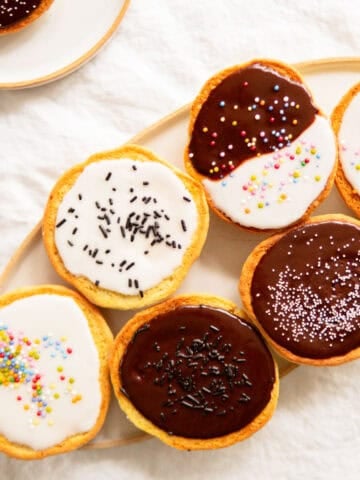 Amerikaner pastries with chocolate and lemon glaze on a platter.