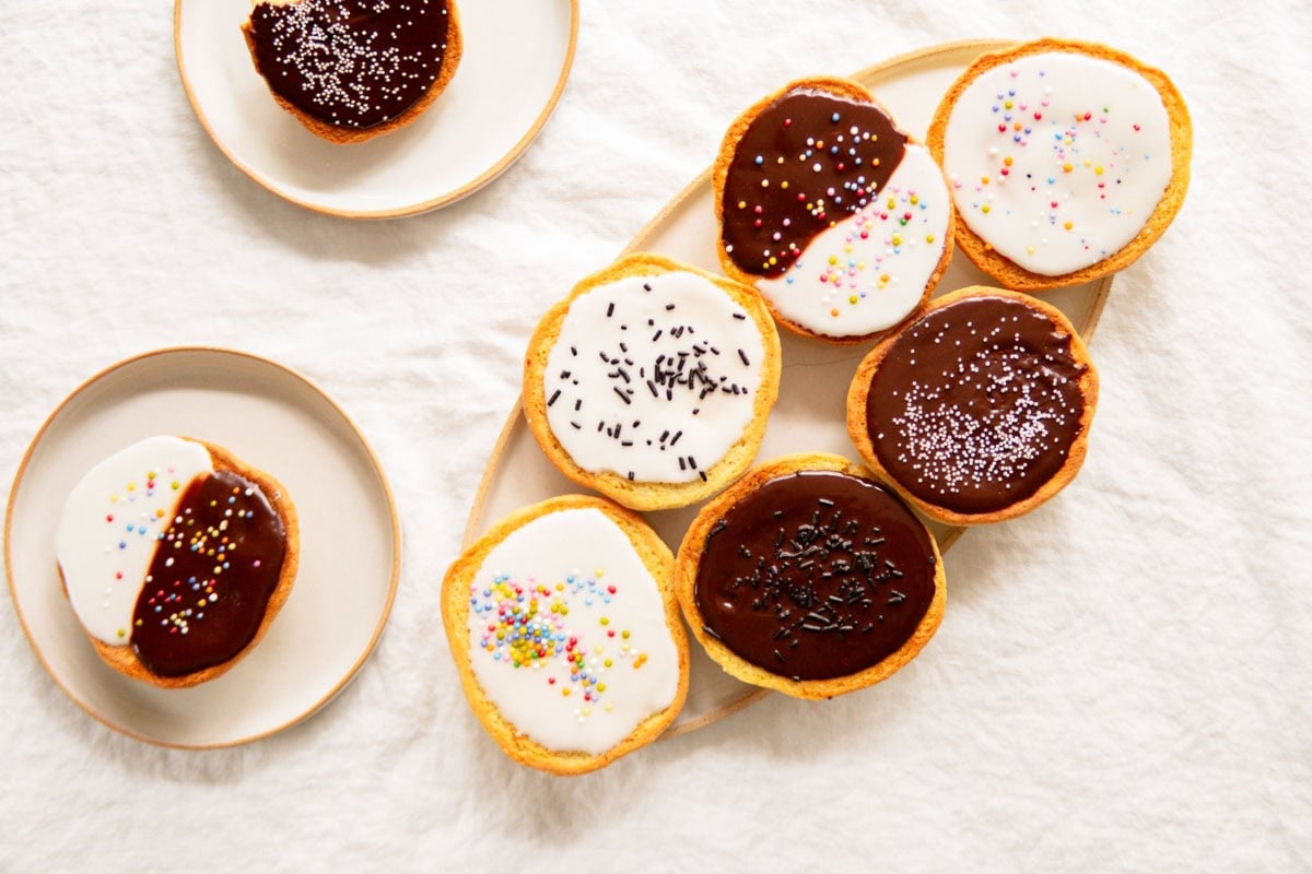 Amerikaner pastries on a serving platter with sprinkles on top.
